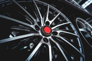Close-up view of a black and silver SSR GTX02 alloy wheel rim with a red center cap, displayed indoors under bright lighting.
